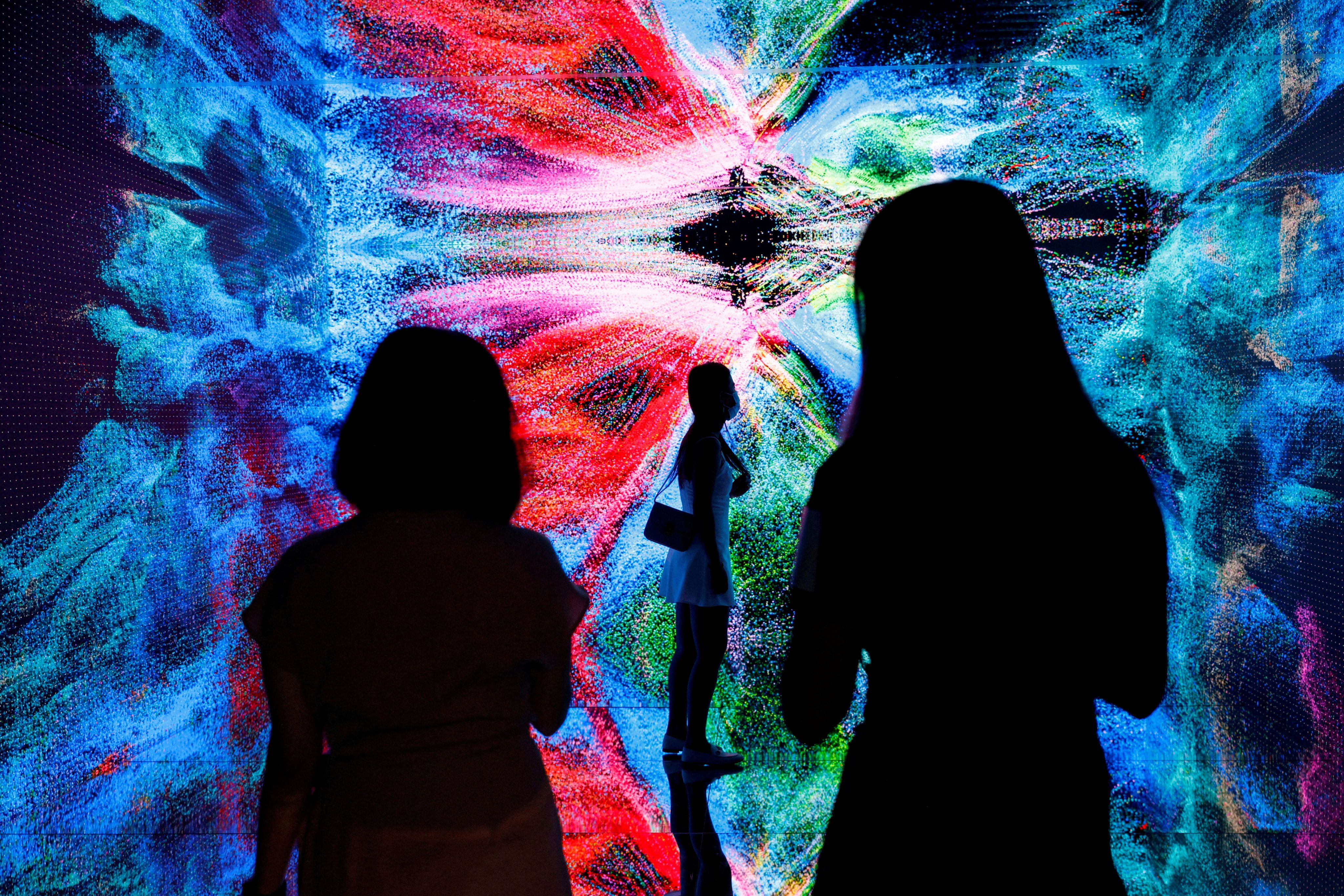Visitors are pictured in front of an immersive art installation