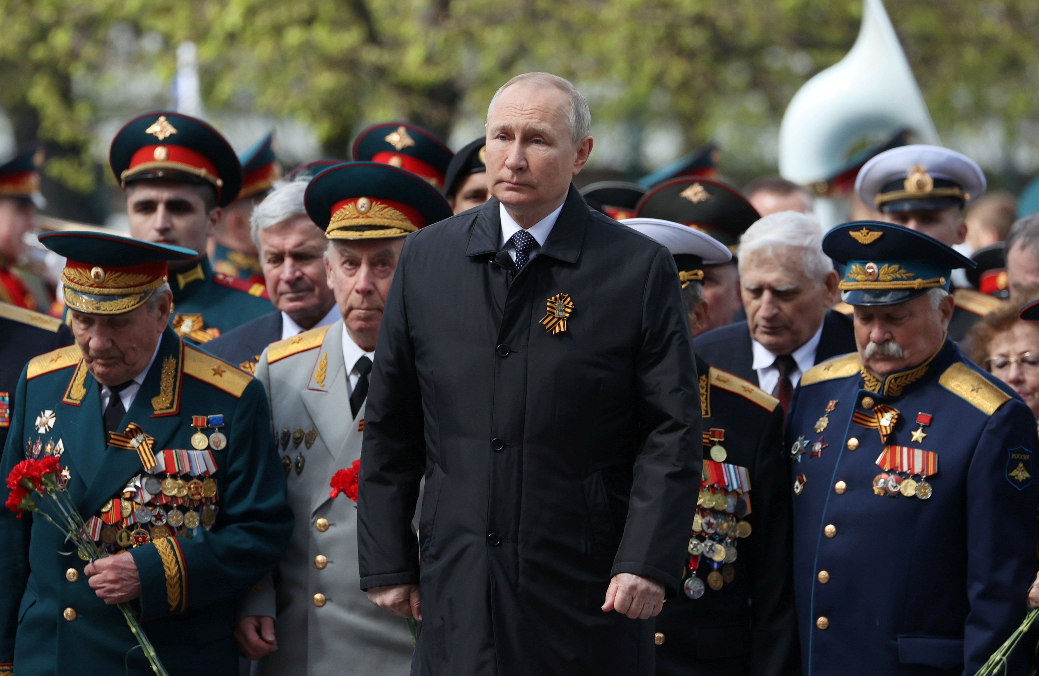 Russia's president Vladimir Putin in font of military personnel at the Victory Day celebrations